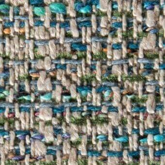 Woven fabric texture, beige and multi-colored tweed, irregular pattern with teal, blue, orange, green, and purple weft threads, substantial weight.