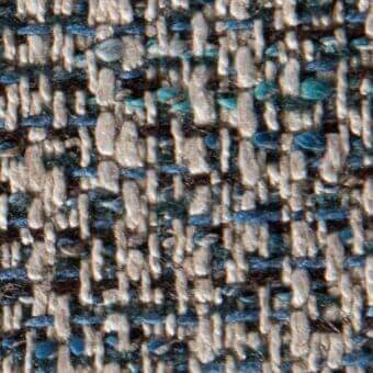 Teal and beige tweed fabric texture with speckled pattern, irregular weave, and charcoal gray threads, suggesting a durable, matte woolen blend.
