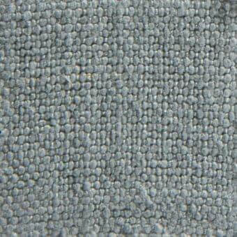 Woven fabric texture in muted gray-blue, densely nubby with rounded protrusions, matte finish, sample labeled "romeo 13059" verzelloni.