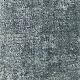 Woven fabric texture, muted gray tone, irregular looped pile with horizontal striations and subtle discoloration, verzelloni serapi 17028.