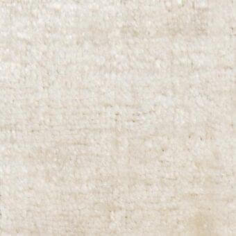 Off-white looped fabric texture with mottled appearance, irregular nubby pile, and diffused light reflection; warm creamy beige and ivory tones.