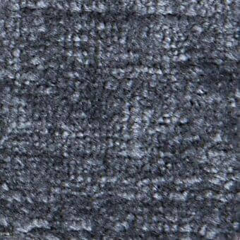 Dark gray mottled texture with granular, uneven surface and subtle tonal variations, displaying faint diagonal linear patterns and diffuse lighting.