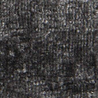 Dark woven textile texture with faint vertical lines and embedded text including “verzelloni,” “fabric,” and “serapi” markings.