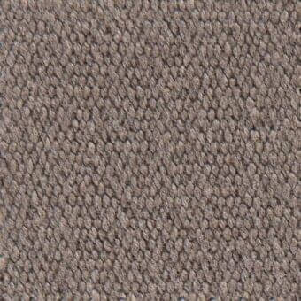 Woven fabric texture in taupe features a dense, nubby surface with small rounded protrusions and a repeating dimensional pattern.