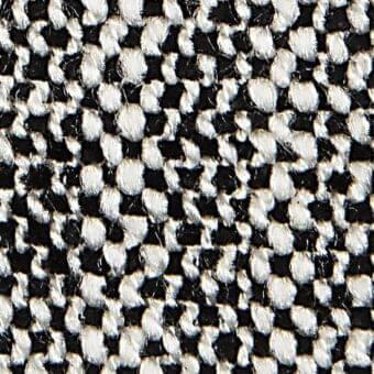 Woven checkerboard fabric with black and off-white yarns, featuring a thick, nubby, irregular texture and looped construction.