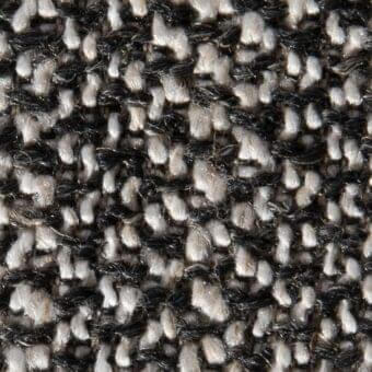 Woven tweed-like fabric texture, black and off-white speckled pattern, dense raised weave with yarn knots, Klimt 14055 Vezzelloni collection.