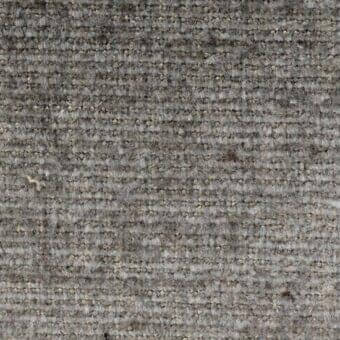 Gray woven fabric texture with vertical rib, heathered tones, and scattered yellow/blue flecks; label reads “verzelloni lena 17029”.