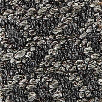 Woven fabric texture in gray and silver tones features an irregular, pebble-like pattern with visible knots and looped pile construction; “mevis 19035” text.