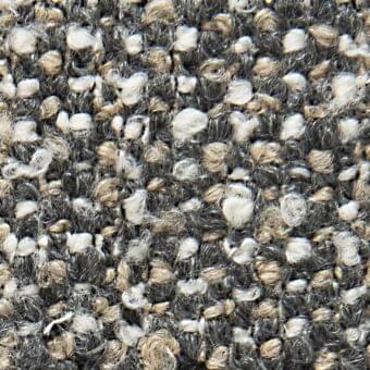Gray and beige tweed fabric texture with speckled white fibers, irregular nubby weave, matte finish, and nuanced tonal depth.