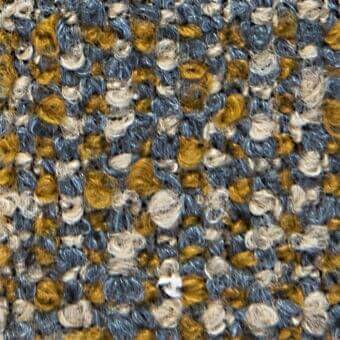Woven fabric texture with speckled gray-blue, golden yellow, and off-white hues; nubby surface features irregular circular patterns and matte finish.