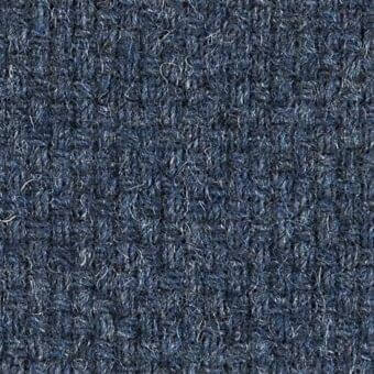 Deep blue woven fabric texture with looped pile, subtle tonal variations, and scattered silver-grey strands; uniform structure, durable appearance.