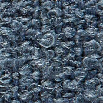 Blue fabric texture with curled fibers, displaying subtle tonal variations and integrated text reading "verzelloni > fabric > calvin 22030".