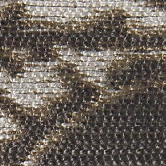 Woven fabric texture, dark gray ribbed pattern, subtle tonal variations, embedded “verzelloni deva 20010” labels, matte finish.