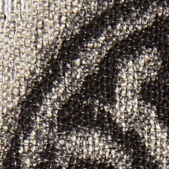 Herringbone fabric texture in muted gray and dark brown tones, dense weave with visible threads, matte finish, sample labeled “deva 20012”.