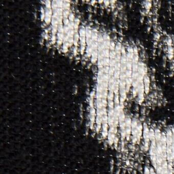 Black woven fabric texture with integrated text reading “verzelloni > fabric > deva 20014”, displaying a mottled, raised surface.