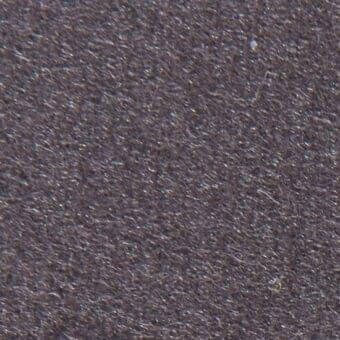 Dark gray woven fabric texture with granular surface, matte finish, directional fiber pattern, and subtle imprinted text identification.