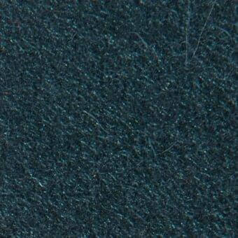 Dark teal fabric texture with dense, raised fibers and a short pile, displaying subtle tonal variations; manufacturer detail visible.