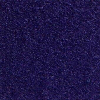 Indigo woven fabric texture displaying a dense, slightly rough pile; studio sample with embedded text “divina3 28045” identifying material origin.