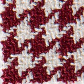 Burgundy and white looped knit yarn texture features a checkerboard pattern with a dense, repeating square grid and soft, fuzzy surface.