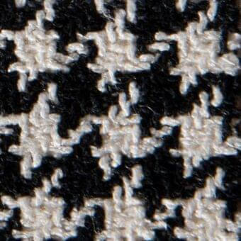 Houndstooth fabric texture with black and off-white yarns in a repeating grid pattern; thick, nubby weave, identified as “Gwen 15058”.
