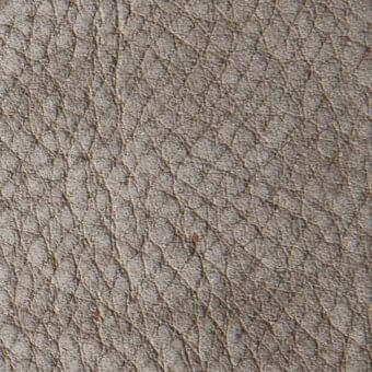Santiago leather texture, muted gray, intricate circular node pattern with web-like creases, matte finish, substantial thickness, dark flecks.