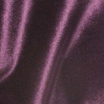 Purple velour fabric swatch, “vismara brilliant velour (b) ve19,” displays a dense, short pile with directional sheen and soft, flowing folds.