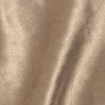 Brilliant Velour fabric sample, warm brown, dense short pile with subtle sheen and vertical highlights from directional nap and soft folds.
