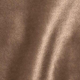 Brilliant Velour fabric sample, warm brown, short pile with vertical nap; soft, draped texture highlighted by diffused lighting.