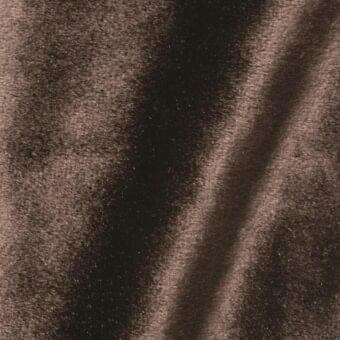 Brown velour fabric texture with a short pile and matte finish, displaying a diagonal fold and tonal variations, labeled “vismara brilliant velour ve07”.