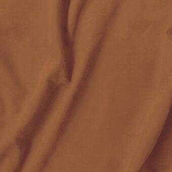 Brown fabric drape with a smooth, lustrous texture and flowing layers, exhibiting soft sheen and subtle tonal variations in diffused light.
