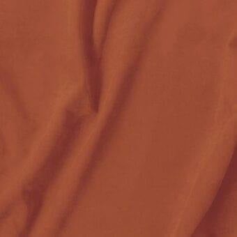 Terracotta fabric swatch with woven texture, displaying gentle folds and a lustrous surface; labeled “vismara > eco nabuk (a) > en68”.