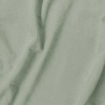 Sage green textile sample with a matte finish, displaying a soft drape and subtle texture; label reads "vismara > eco nabuk (a) > 32 en60".