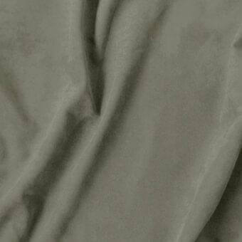 Olive-green textile swatch with matte finish, displaying soft folds and subtle texture; label reads "vismara > eco nabuk (a) > 33 en86".