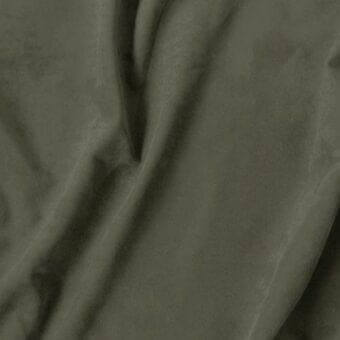 Olive green fabric swatch with matte finish and subtle weave, displaying “vismara eco nabuk” label and soft, pliable texture.