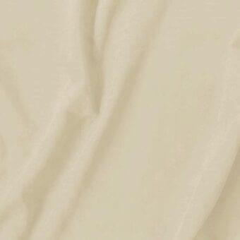 Beige suede fabric swatch with a velvety texture and soft folds, displaying a consistent color and fine nap against a neutral backdrop.