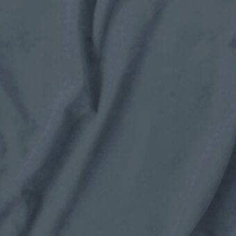 Dark gray fabric swatch with matte texture, visible folds, and “vismara eco nabuk” label against a neutral gray background.