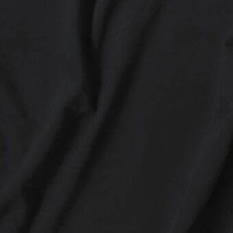 Black fabric texture with subtle sheen, dense folds, and printed text “vismara > eco nabuk (a) > 50 en13” indicating material details.