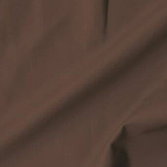 Brown extra leather swatch with soft texture, displaying tonal variations and matte finish in draped, undulating folds.