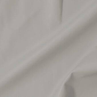 Vismara leather swatch, light gray, soft texture, with gentle folds displaying drape and flexibility against a neutral backdrop.