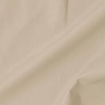 Leather swatch in muted beige, displaying a smooth, finely grained texture with subtle sheen and soft draping; sample labeled “bre679”.