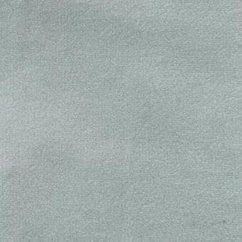 Matt velour fabric texture in pale blue-green, short-pile with a dense nap, displaying a finely granular, uniformly matte surface; vismara label.