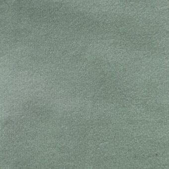 Dusty green matt velour fabric texture, short pile with directional nap, uniform weave, matte finish, neutral background sample.
