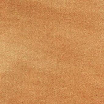 Matt velour fabric texture in muted orange, close-up view with uniform grain and a velvety matte finish; Vismara label visible.