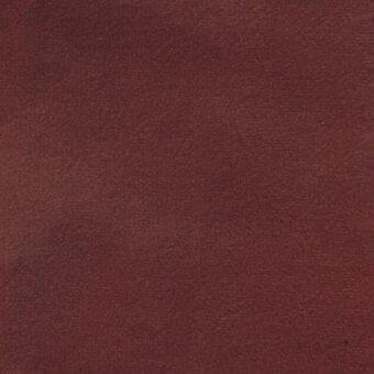 Matt velour fabric texture in reddish-brown, dense short pile with granular matte finish, even lighting, tonal variations.