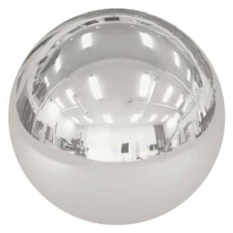 Polished chrome sphere reflecting interior with white walls, fluorescent lights, chair, and display stand; mirror finish distorts room perspective.